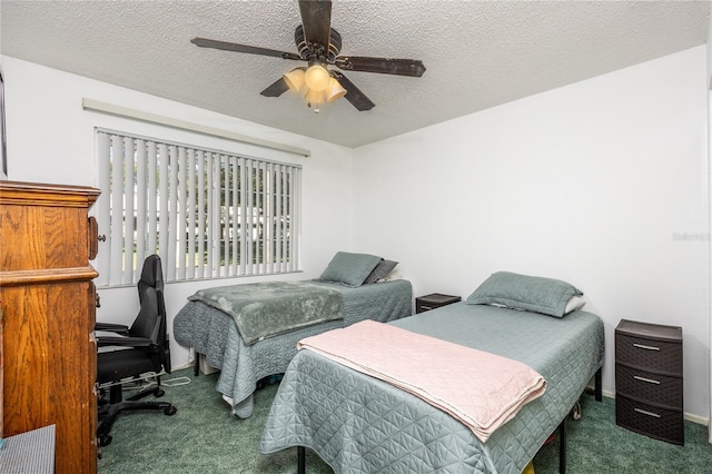 bedroom featuring ceiling fan, dark carpet, and a textured ceiling