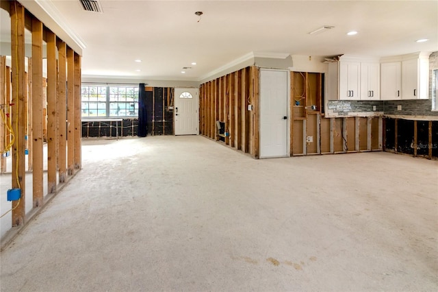 interior space featuring crown molding and light carpet