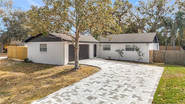 ranch-style home with a front yard and a garage