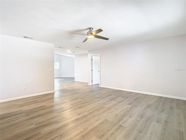 empty room with light wood-type flooring and ceiling fan