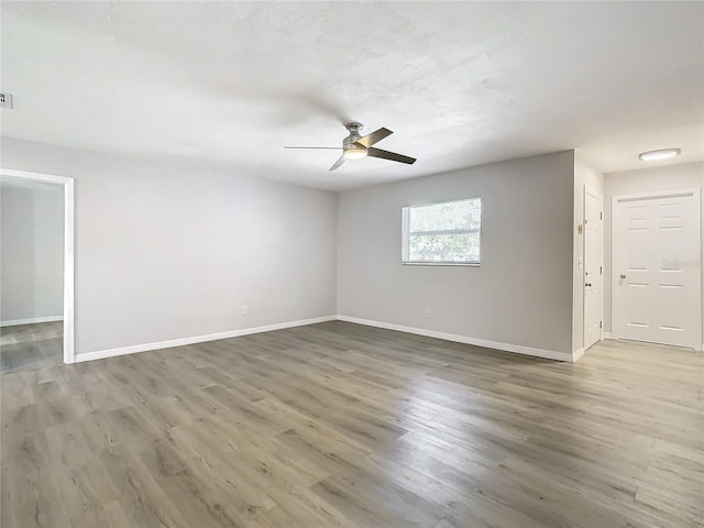 spare room with hardwood / wood-style floors and ceiling fan