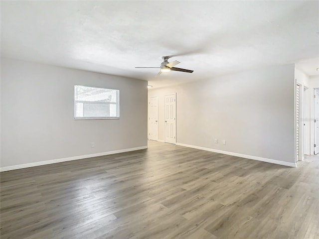 unfurnished room featuring dark hardwood / wood-style floors and ceiling fan