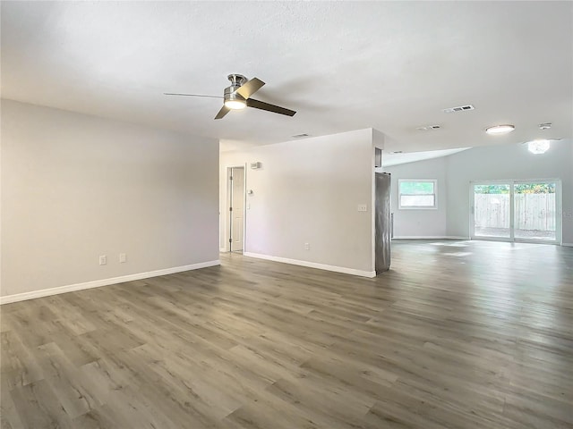 empty room with ceiling fan, dark hardwood / wood-style flooring, and lofted ceiling