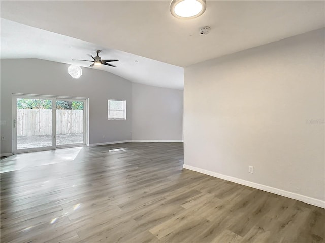 spare room featuring hardwood / wood-style floors, ceiling fan, and vaulted ceiling