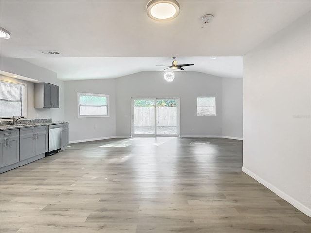 kitchen with light wood-type flooring, gray cabinetry, ceiling fan, sink, and dishwasher