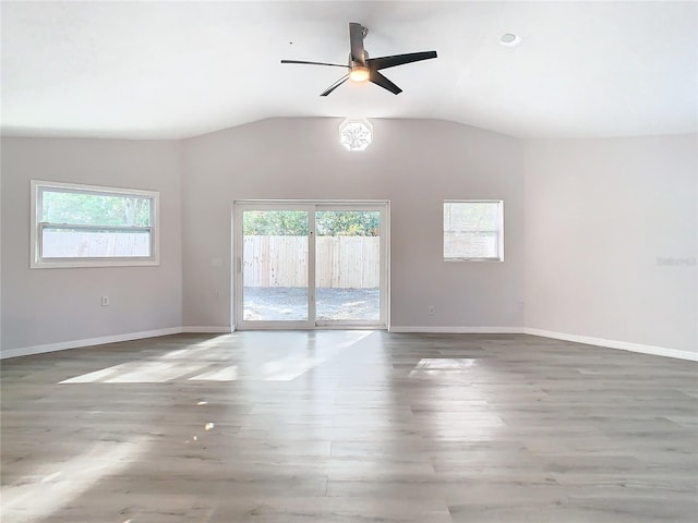 spare room with hardwood / wood-style flooring, ceiling fan, and vaulted ceiling