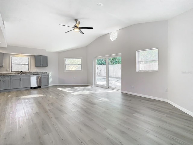 unfurnished living room featuring light hardwood / wood-style flooring, ceiling fan, and lofted ceiling