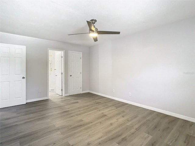 unfurnished bedroom featuring dark hardwood / wood-style floors and ceiling fan