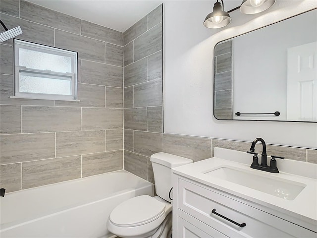 full bathroom with vanity, tiled shower / bath combo, tile walls, and toilet