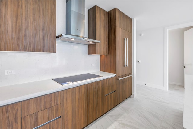 kitchen with black electric cooktop, decorative backsplash, and wall chimney range hood