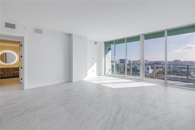 empty room with a wall of windows and sink