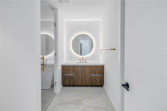 bathroom with vanity and a tub