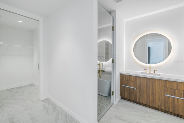 bathroom featuring a tub to relax in and vanity