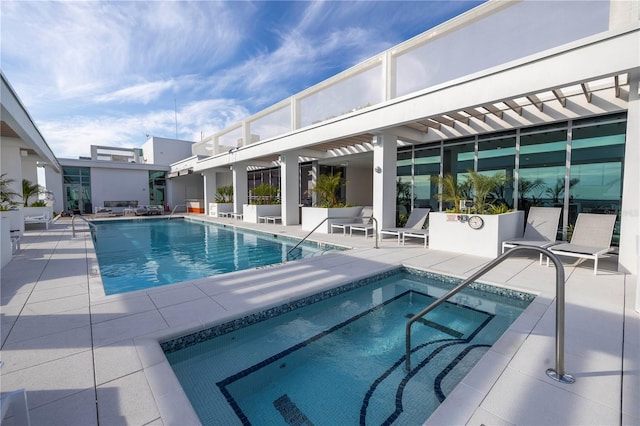 view of pool with a patio area and a community hot tub