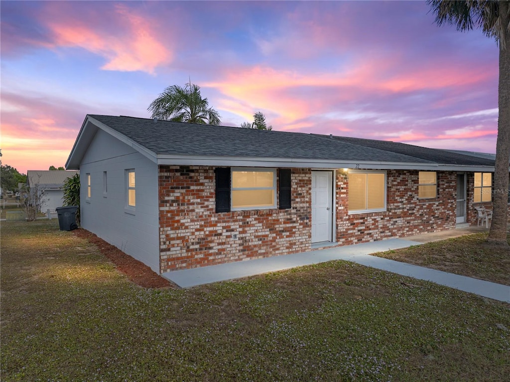 ranch-style house with a yard