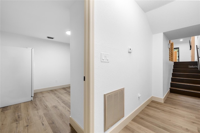 corridor with light wood-type flooring