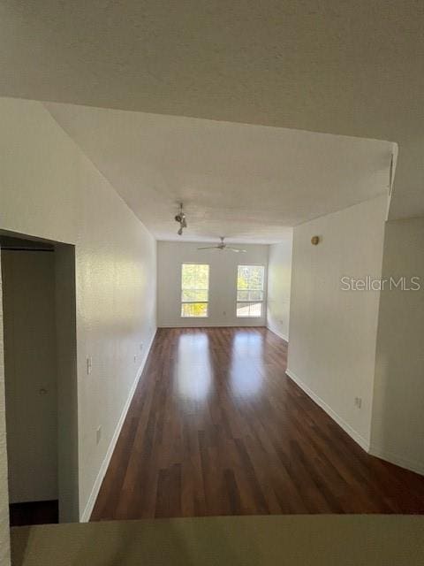 empty room featuring ceiling fan and dark hardwood / wood-style flooring