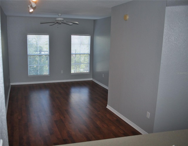 unfurnished room featuring ceiling fan and dark hardwood / wood-style floors