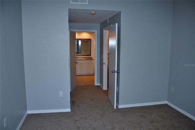 hallway featuring carpet