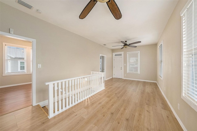 unfurnished room featuring light hardwood / wood-style floors and ceiling fan