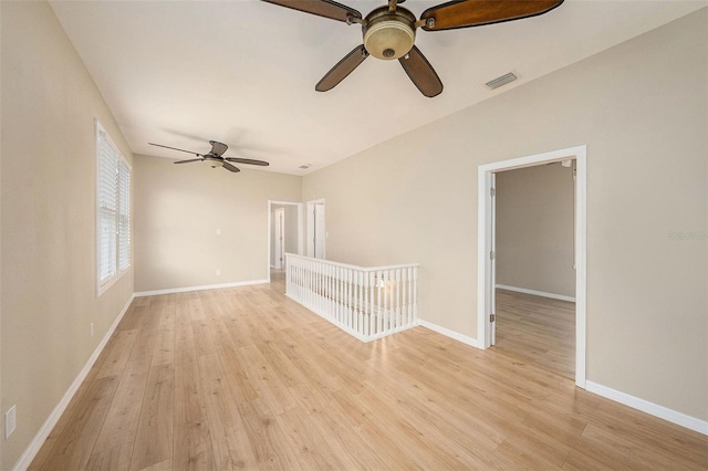 unfurnished room with ceiling fan and light hardwood / wood-style flooring