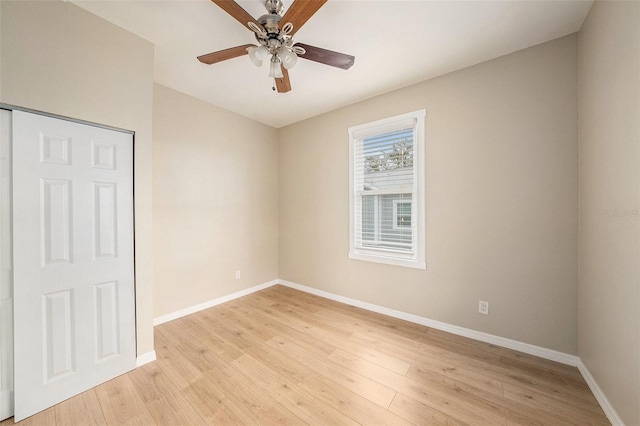 spare room featuring light wood-type flooring and ceiling fan