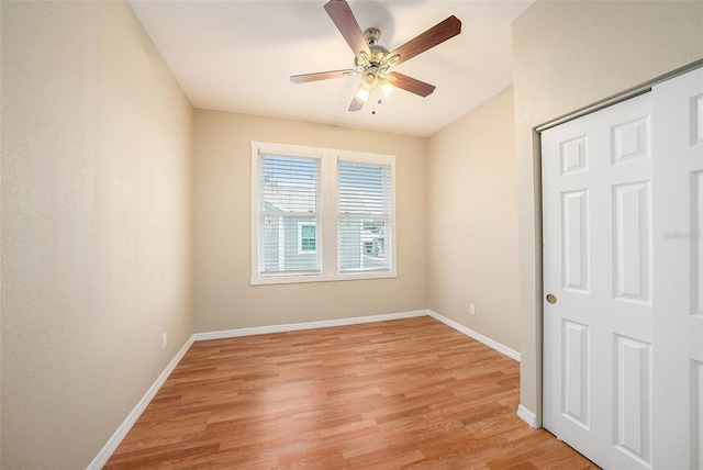 unfurnished bedroom with a closet, light hardwood / wood-style flooring, and ceiling fan