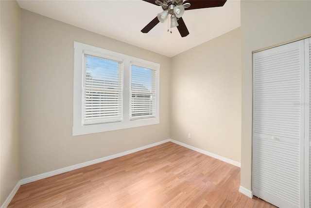 unfurnished bedroom with a closet, light hardwood / wood-style flooring, and ceiling fan