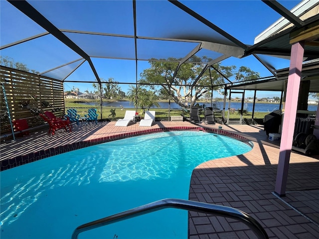 view of swimming pool featuring a patio, a water view, and a lanai