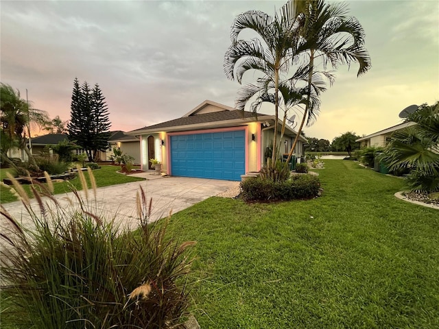 view of front facade with a garage and a yard