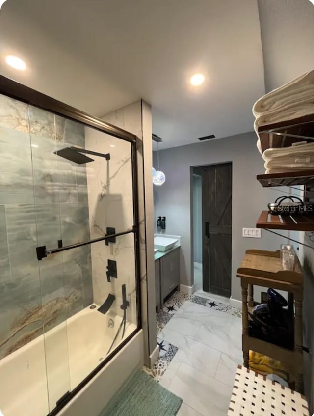 bathroom featuring vanity and enclosed tub / shower combo