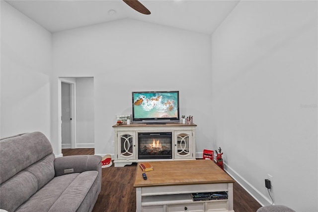 living room with dark hardwood / wood-style flooring, vaulted ceiling, and ceiling fan