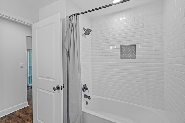 bathroom with shower / bath combo and wood-type flooring