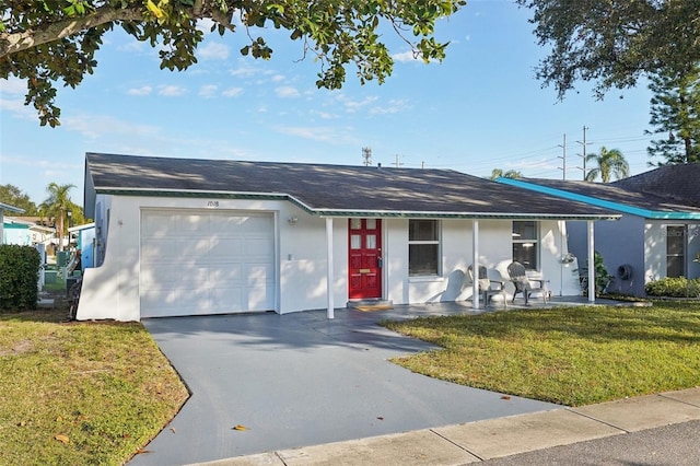 ranch-style home with a front yard and a garage