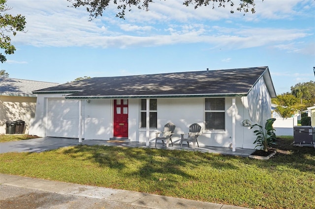 ranch-style home featuring a garage and a front lawn