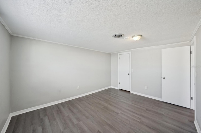 unfurnished room with a textured ceiling, crown molding, and dark wood-type flooring