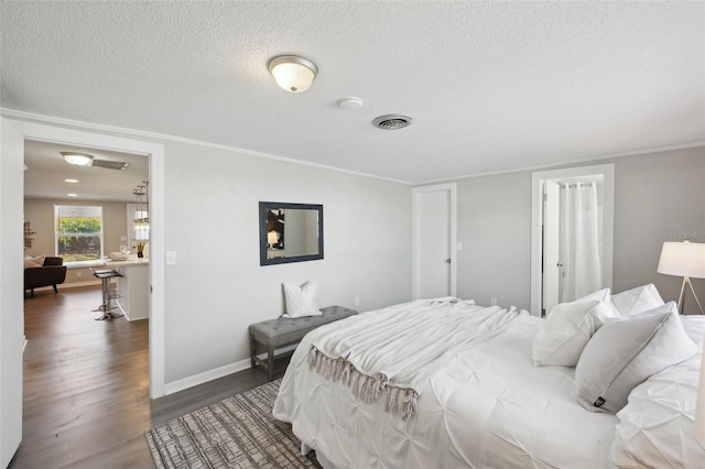 bedroom featuring a textured ceiling and dark wood-type flooring