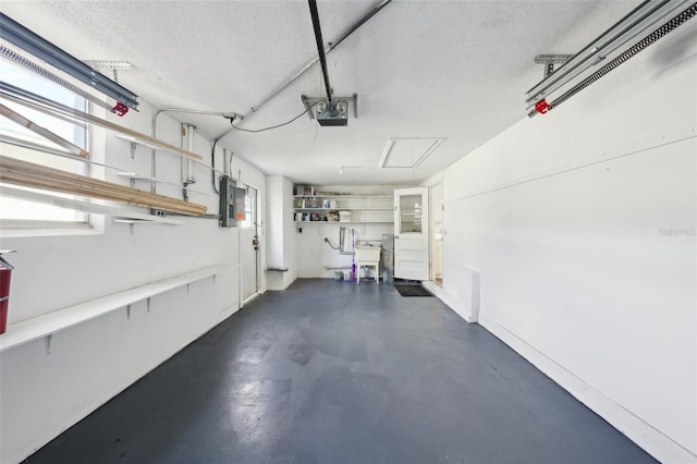 garage featuring electric panel and a garage door opener