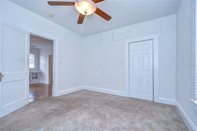 carpeted empty room with ceiling fan