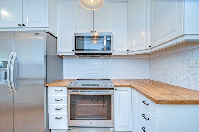 kitchen with white cabinetry, butcher block counters, and appliances with stainless steel finishes