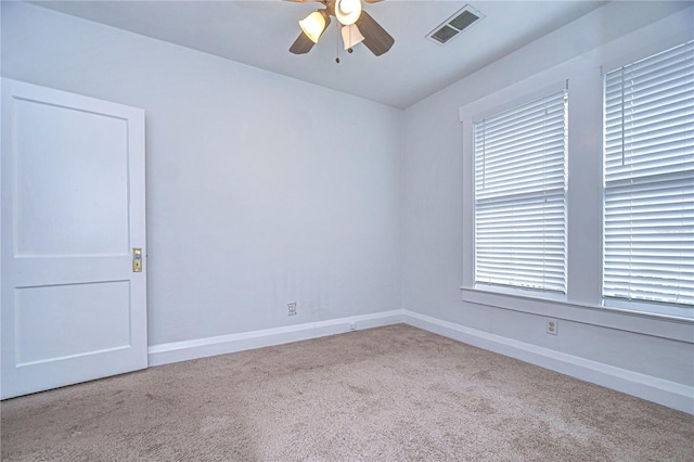 unfurnished room featuring light colored carpet, plenty of natural light, and ceiling fan