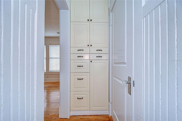 corridor with light hardwood / wood-style floors