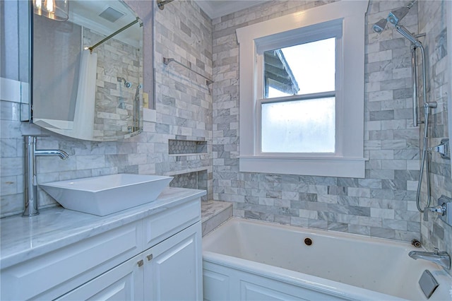 bathroom with tasteful backsplash, tile walls, vanity, and shower / bath combo