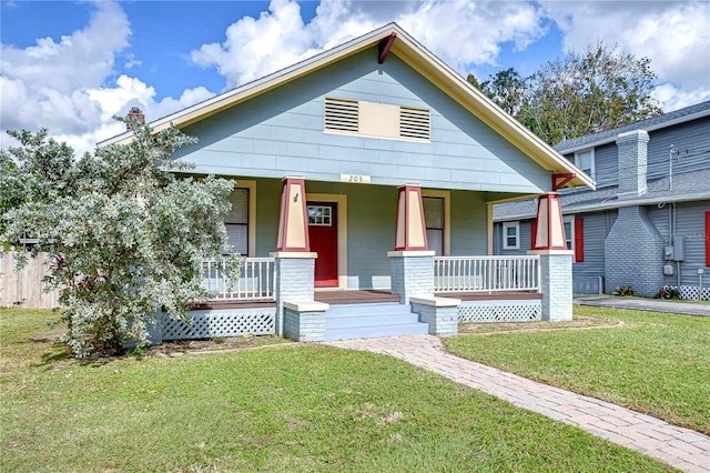 view of front of house with covered porch and a front yard