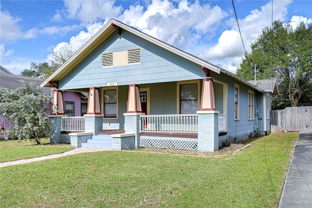 bungalow-style house with a front lawn and a porch