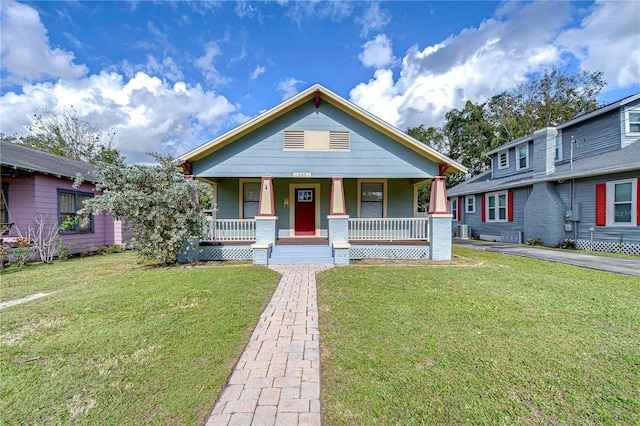 bungalow featuring a front yard and covered porch