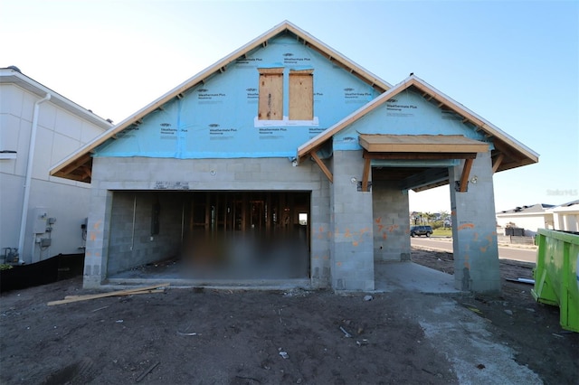 view of front of house featuring a garage and concrete block siding