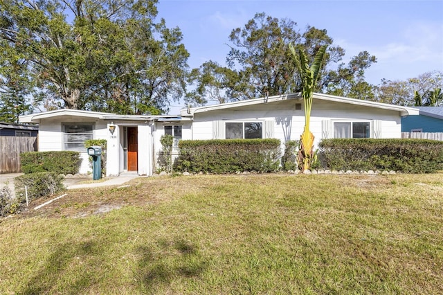 ranch-style home featuring a front yard