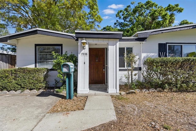 entrance to property featuring fence