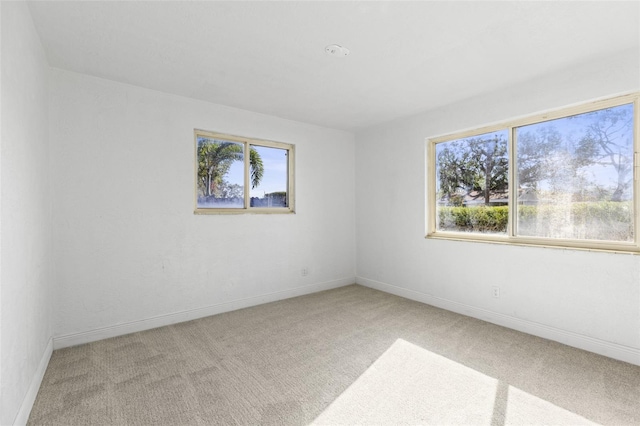 carpeted spare room with baseboards